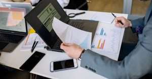 A professional working on a laptop at an office desk