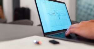 A group of beginners engaging in a data analysis training session with laptops.