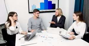 A diverse team analyzing data on laptops in a modern office
