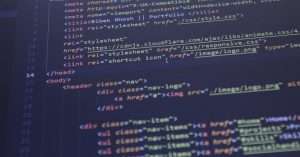 A group of diverse students learning coding in a classroom setting