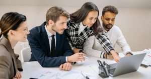A team collaborating on laptops in a modern office environment
