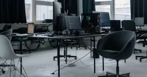 A professional workspace featuring a laptop and cloud computing graphics.