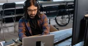 a developer coding on a laptop in a modern office