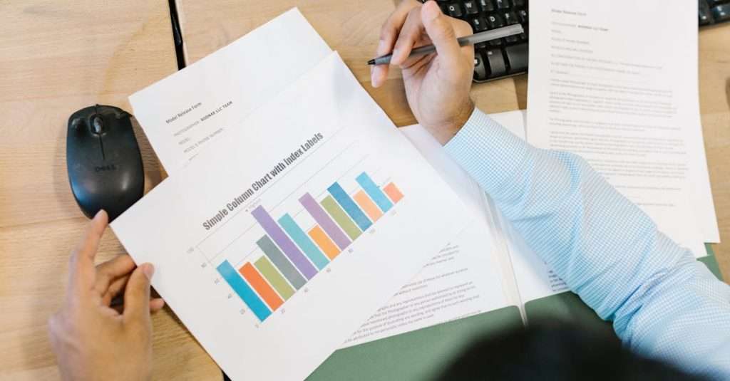 A junior data analyst using a laptop in a modern office environment