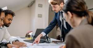 A team of professionals discussing project plans in an office environment