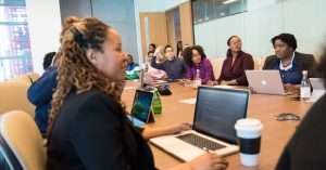 A professional training session with a laptop on a desk in a modern office.