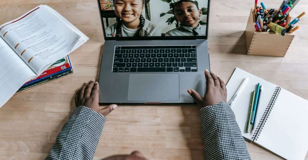 A modern workspace with a laptop and notes for online learning.