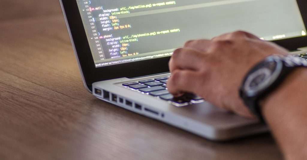 a person working on a laptop in a modern office setting