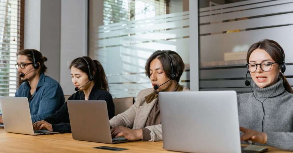 IT support staff collaborating at a workstation