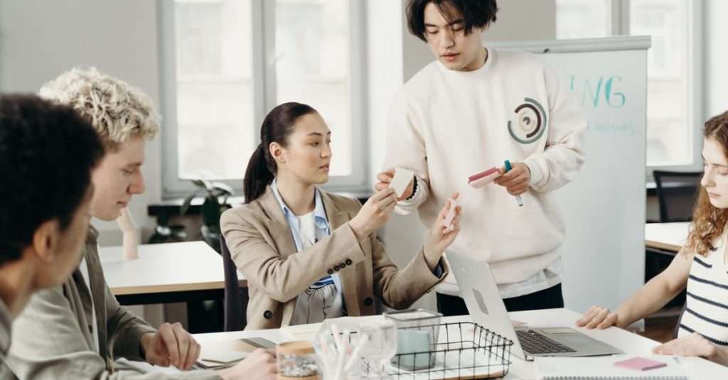 A group of young professionals collaborating in a modern office environment.