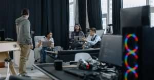 A diverse team of QA professionals engaged in a discussion around software testing strategies.