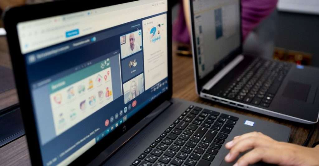 team members engaging in a virtual meeting on laptops